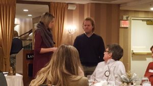 Marquette West Rotary President Amanda Filizetti giving Jake Bilodeau his pin.