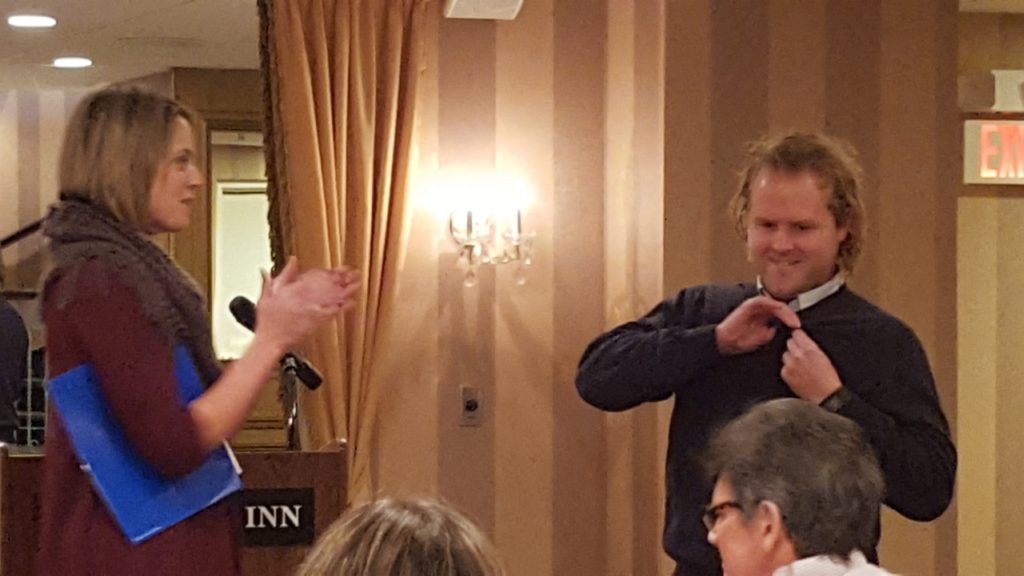 Jake putting his new Rotary Club pin on.
